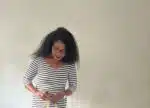 Black woman wearing striped dress