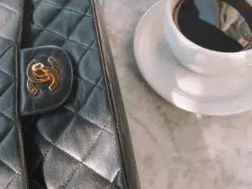 flatlay of chanel bag and black coffee on a marble bistro table