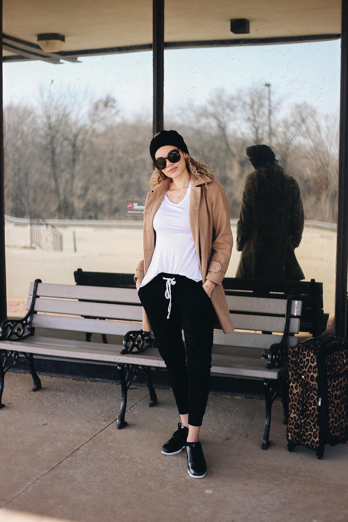 comfy airport outfit with joggers and a camel coat