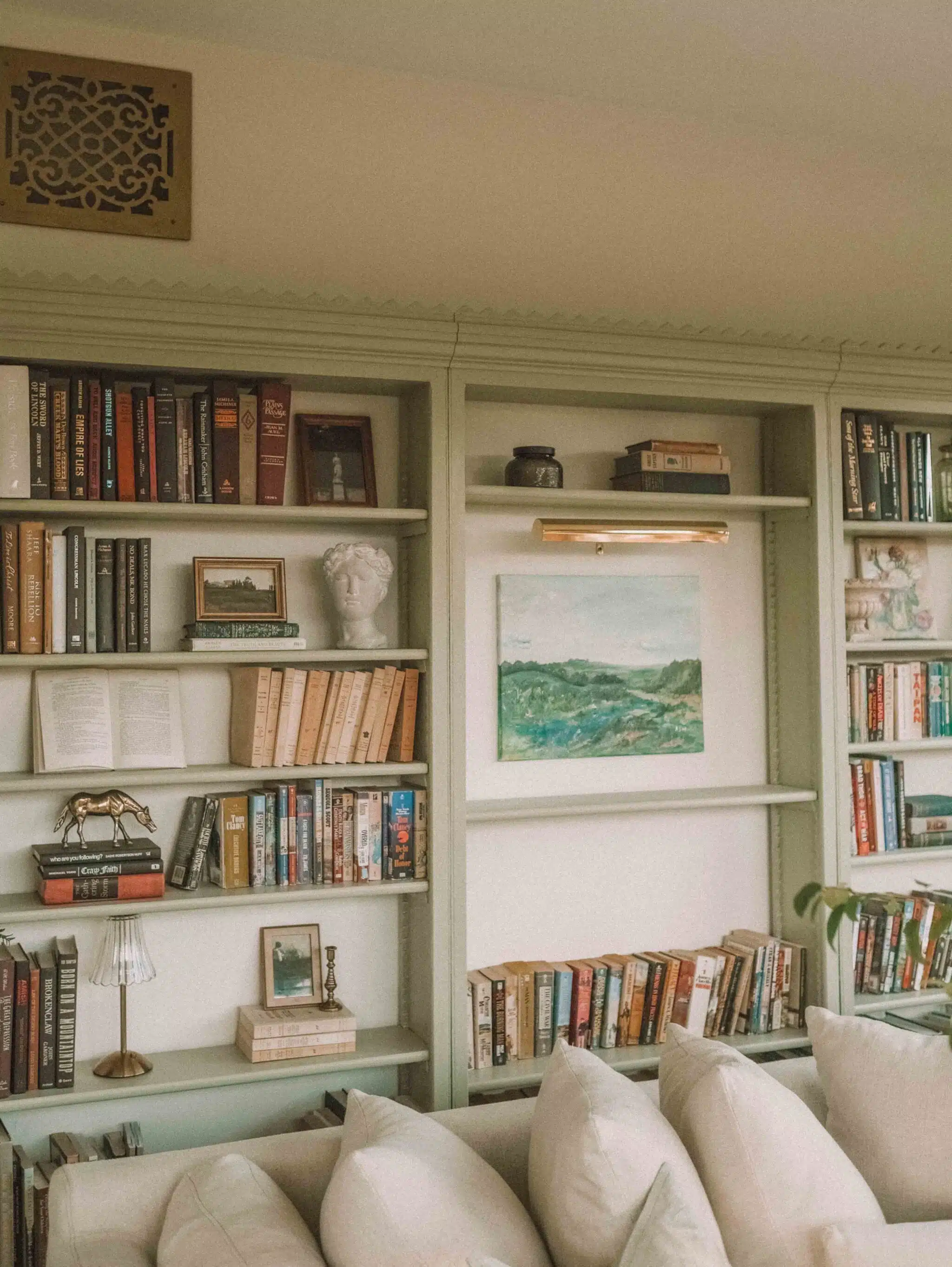 sage green bookcases in home library