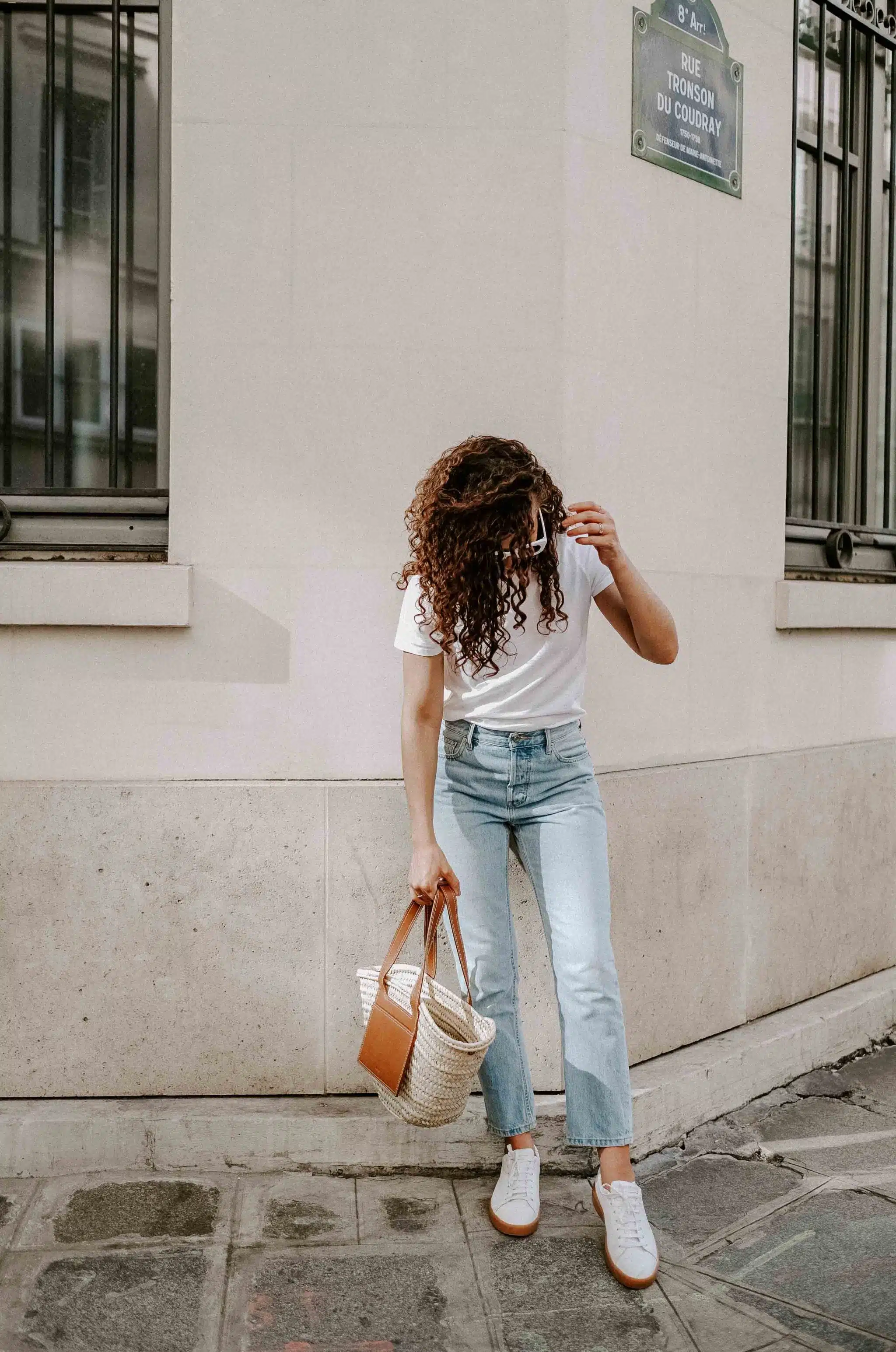 straw bag and straight leg jeans