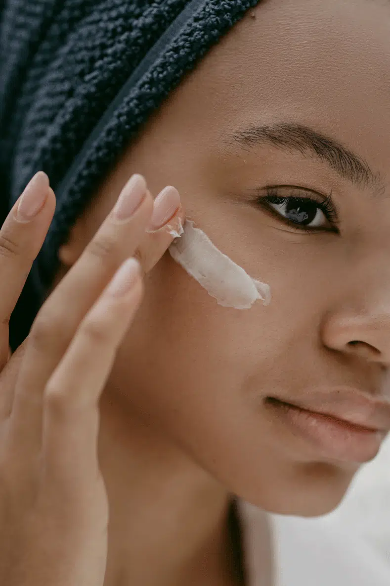 black woman applying eye cream